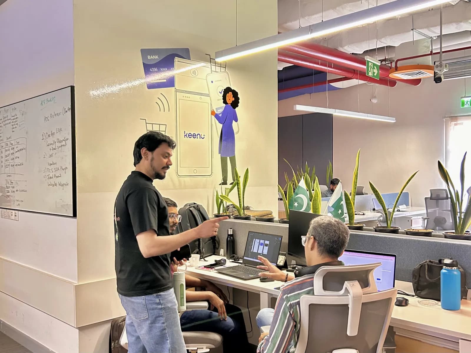 Keenu team members working together at their desks