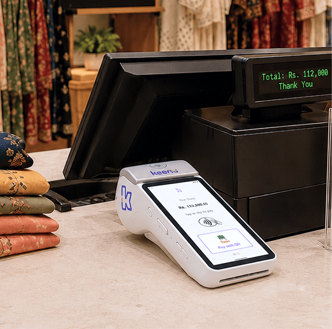 Store staff at the existing checkout counter where Keenu connects to the current setup