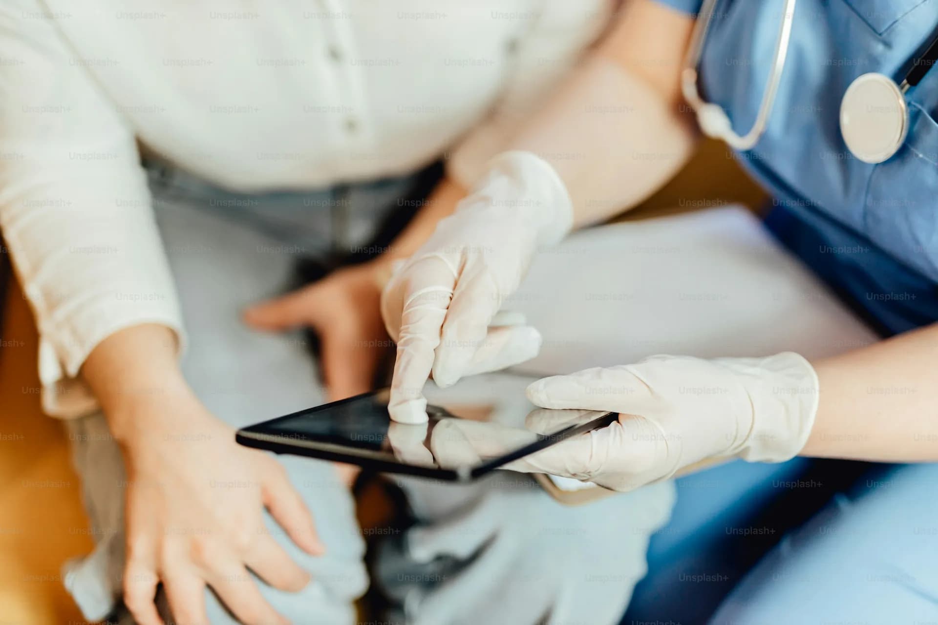 A clinician reviewing a tablet with a patient
